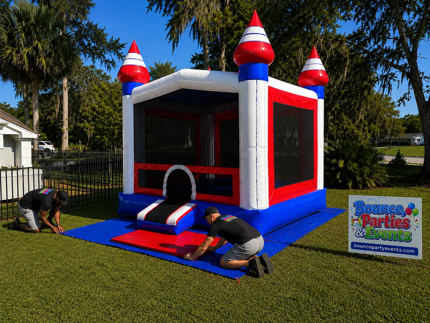 Bounce, Parties & Events crew staking and securing a bounce house before setup